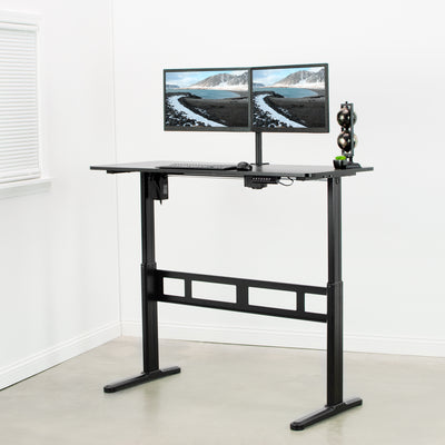 Black electric height adjustable desk with extra leg support bracket.