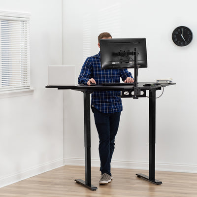 A man working at an efficient ergonomic workstation.