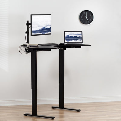 Electric sit-to-stand desk at standing work height for productive ergonomic office work.
