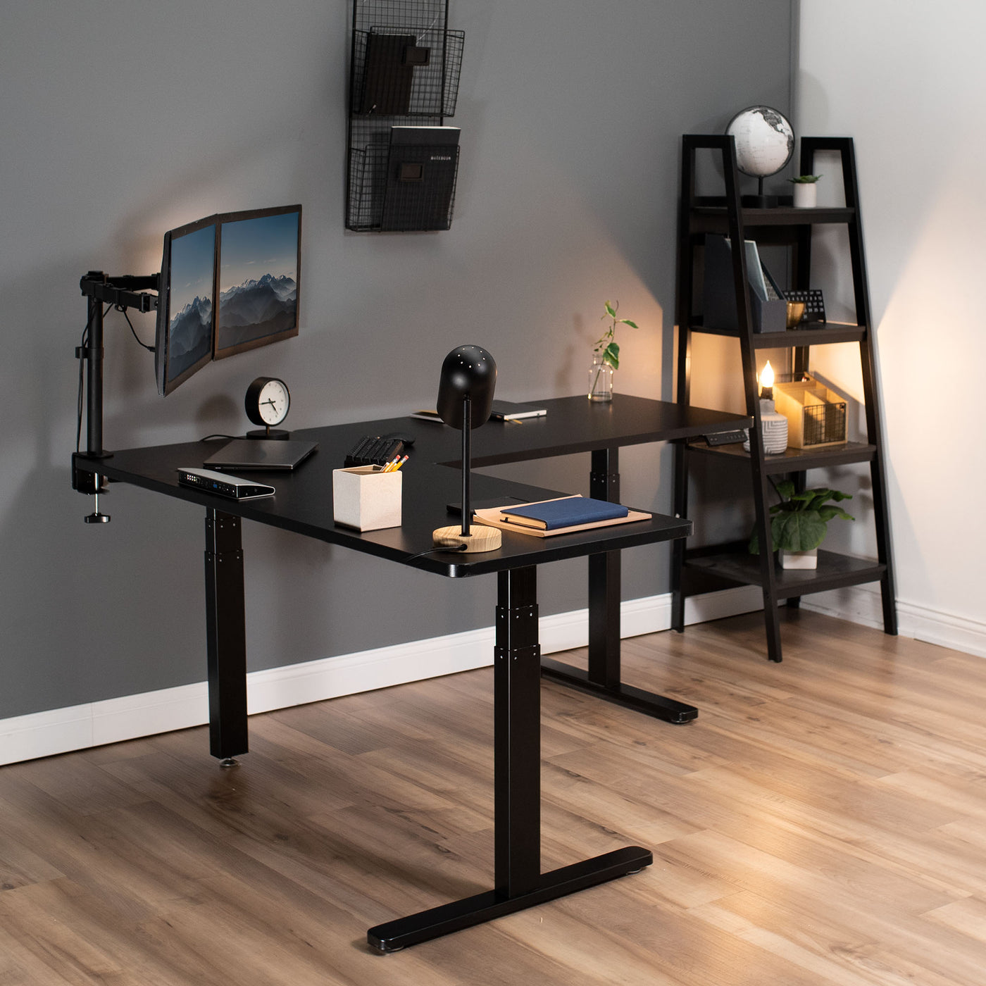 Modern furnished office space with electric desk for ergonomic workspaces.