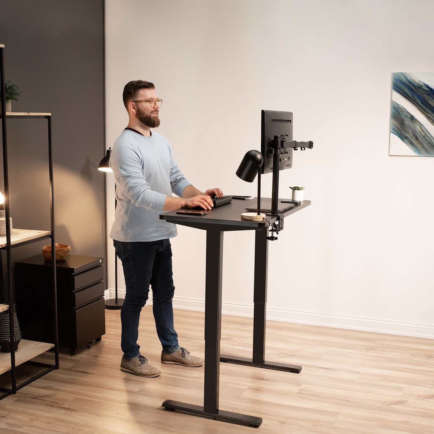A man working at a standing desk.