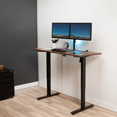 Heavy-duty rustic electric height adjustable desktop workstation for active sit or stand efficient workspace.