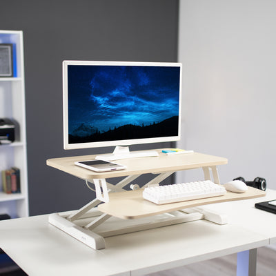 Heavy-duty height adjustable desk converter platform with 2 tiers.